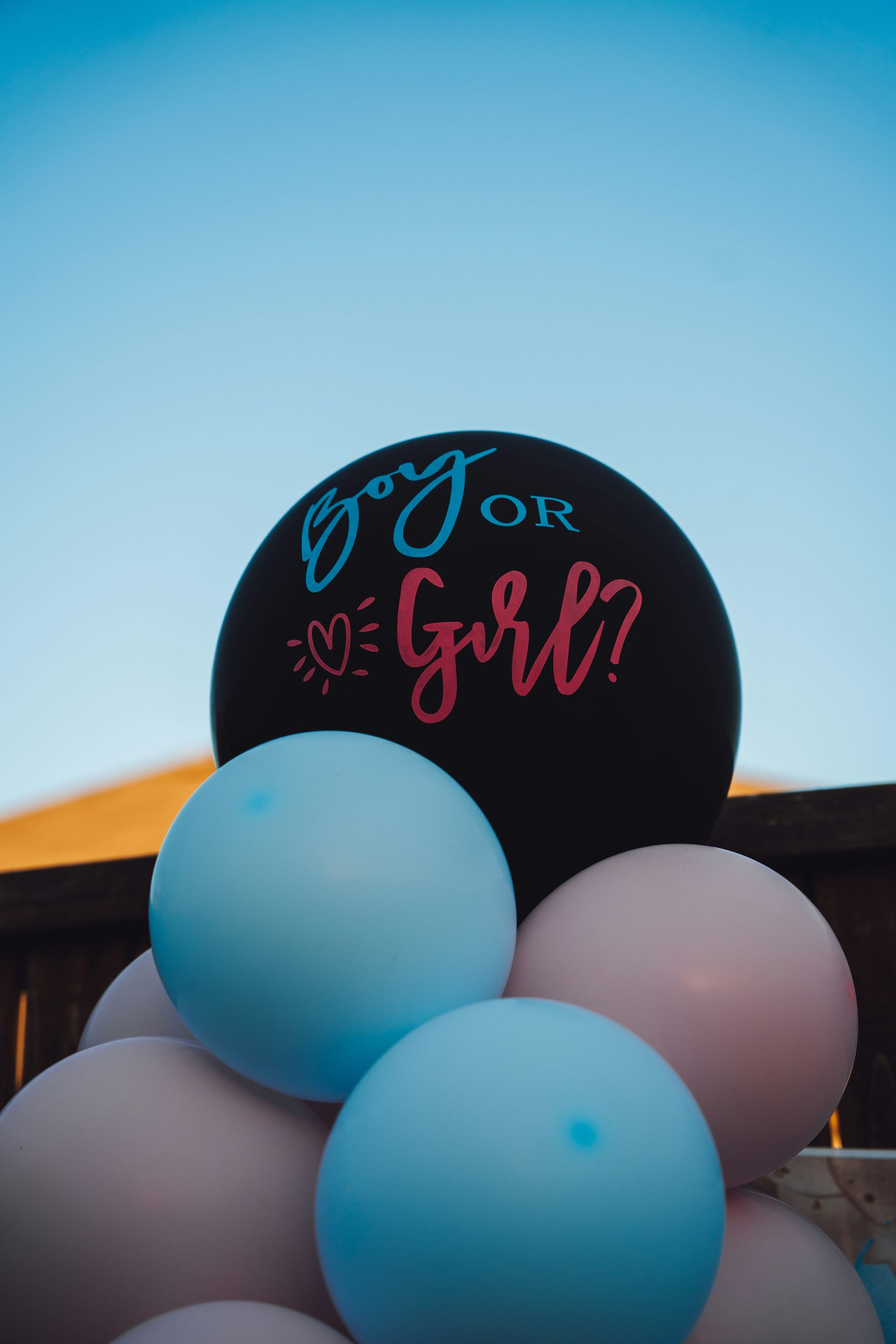 A bunch of balloons that are in front of a building